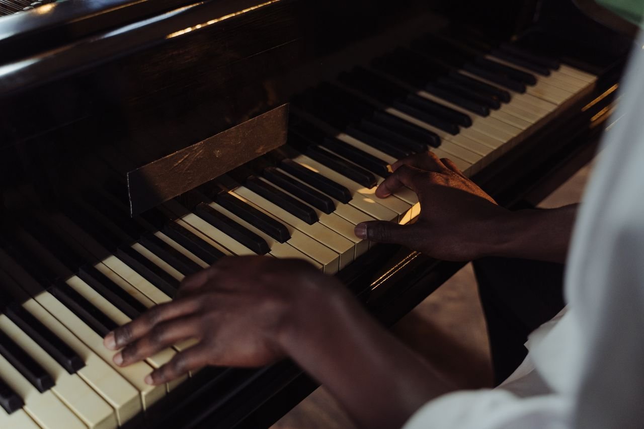 A detailed view of hands skillfully playing piano keys, emphasizing musical expression.